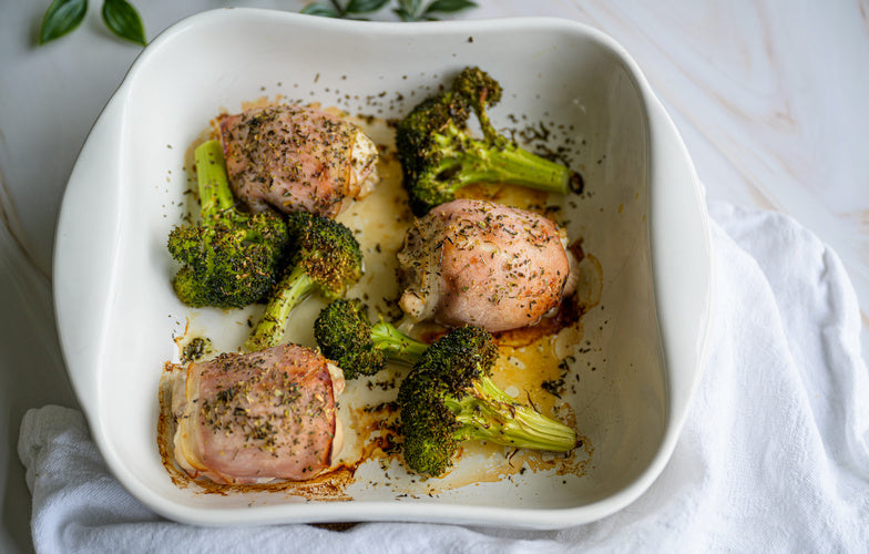 Kip met bacon en broccoli in een witte ovenschaal, geroosterd in de oven — koolhydraatarm diner recept